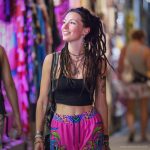 Alternative looking hippy style woman inside a yoga studio wearing Alex Tooth Radiant Bloom FlowState Pants.