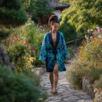 Alternative looking hippy woman in an outdoor setting wearing Alex Tooth Emerald StarGate Flow Kimono Robe.