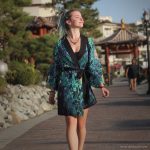Alternative looking hippy woman in an outdoor setting wearing Alex Tooth Emerald StarGate Flow Kimono Robe.