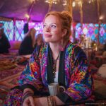 Hippy woman in boho cafe with tattoos wearing Alex Tooth Inner Flight MoonFlow Kimono robe.