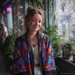 Hippy woman in boho cafe with tattoos wearing Alex Tooth Inner Flight MoonFlow Kimono robe.