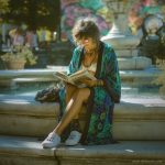 Hippy woman by water fountain sitting reading a book wearing Alex Tooth Emerald StarGate MoonFlow Kimono robe.