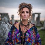 Alternative hippy boho style woman standing outside wearing buckle up fleece lined Alex Tooth Inner Flight Vision Robe.