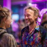 Smart looking alternative hippy style man standing in a inside social function setting wearing an Alex Tooth Inner Flight InnerLight Shirt.