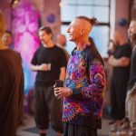 Smart looking alternative hippy style man standing in a inside social function setting wearing an Alex Tooth Inner Flight InnerLight Shirt.