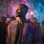 Alternative edgy looking hippy man standing looking cool wearing an Alex Tooth Radiant Bloom Wayfarer Blazer.