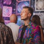 Alternative edgy looking hippy man standing looking cool wearing an Alex Tooth Radiant Bloom Wayfarer Blazer.
