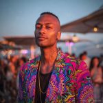 Alternative edgy looking hippy man standing looking cool wearing an Alex Tooth Radiant Bloom Wayfarer Blazer.