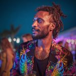 Alternative edgy looking hippy man standing looking cool wearing an Alex Tooth Inner Light Wayfarer Blazer.