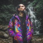 Alternative hippy looking man standing outside wearing Alex Tooth Inner flight Pathfinder Jacket.