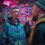 Alternative hippy looking man standing outside wearing Alex Tooth Emerald StarGate Pathfinder Jacket.