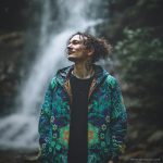 Alternative hippy looking man standing outside wearing Alex Tooth Emerald StarGate Pathfinder Jacket.
