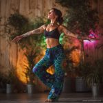 Alternative looking hippy style woman inside a yoga studio wearing Alex Tooth Emerald StarGate FlowState Pants.