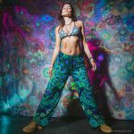 Alternative looking hippy style woman inside a yoga studio wearing Alex Tooth Emerald StarGate FlowState Pants.