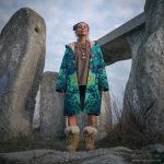 Alternative hippy boho style woman standing outside wearing buckle up fleece lined Alex Tooth Emerald StarGate Vision Robe.