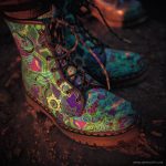 A pair of combat boots at a music festival, the boots are Alex Tooth Emerald StarGate Spirit Boots.