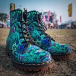 A pair of combat boots at a music festival, the boots are Alex Tooth Emerald StarGate Spirit Boots.