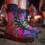 A pair of combat boots at a music festival, the boots are Alex Tooth Radiant Bloom Spirit Boots.