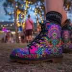 A pair of combat boots at a music festival, the boots are Alex Tooth Radiant Bloom Spirit Boots.