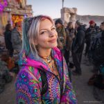 Alternative looking hippy style woman in a winter season outdoor setting wearing an Alex Tooth Radiant Bloom Nomad Coat Long Puffer Winter Coat.