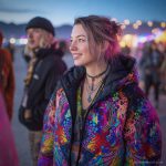 Alternative looking hippy style woman in a winter season outdoor setting wearing an Alex Tooth Inner Flight Nomad Coat Long Puffer Winter Coat.