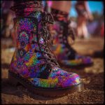 A pair of combat boots at a music festival, the boots are Alex Tooth Inner flight Spirit Boots.