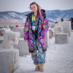Alternative looking hippy style woman in a winter season outdoor setting wearing an Alex Tooth Inner Flight Nomad Coat Long Puffer Winter Coat.