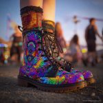 A pair of combat boots at a music festival, the boots are Alex Tooth Inner flight Spirit Boots.